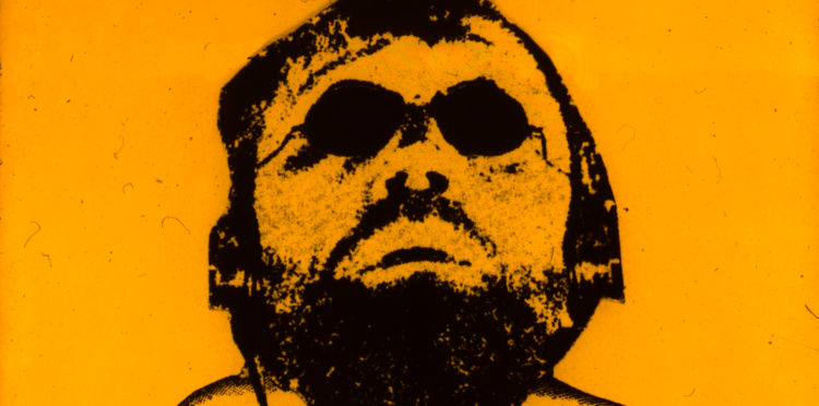 Drawn figure of a male face with sunglasses on an orange background